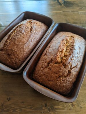 Two loaves of pumpkin bread in loaf pans.